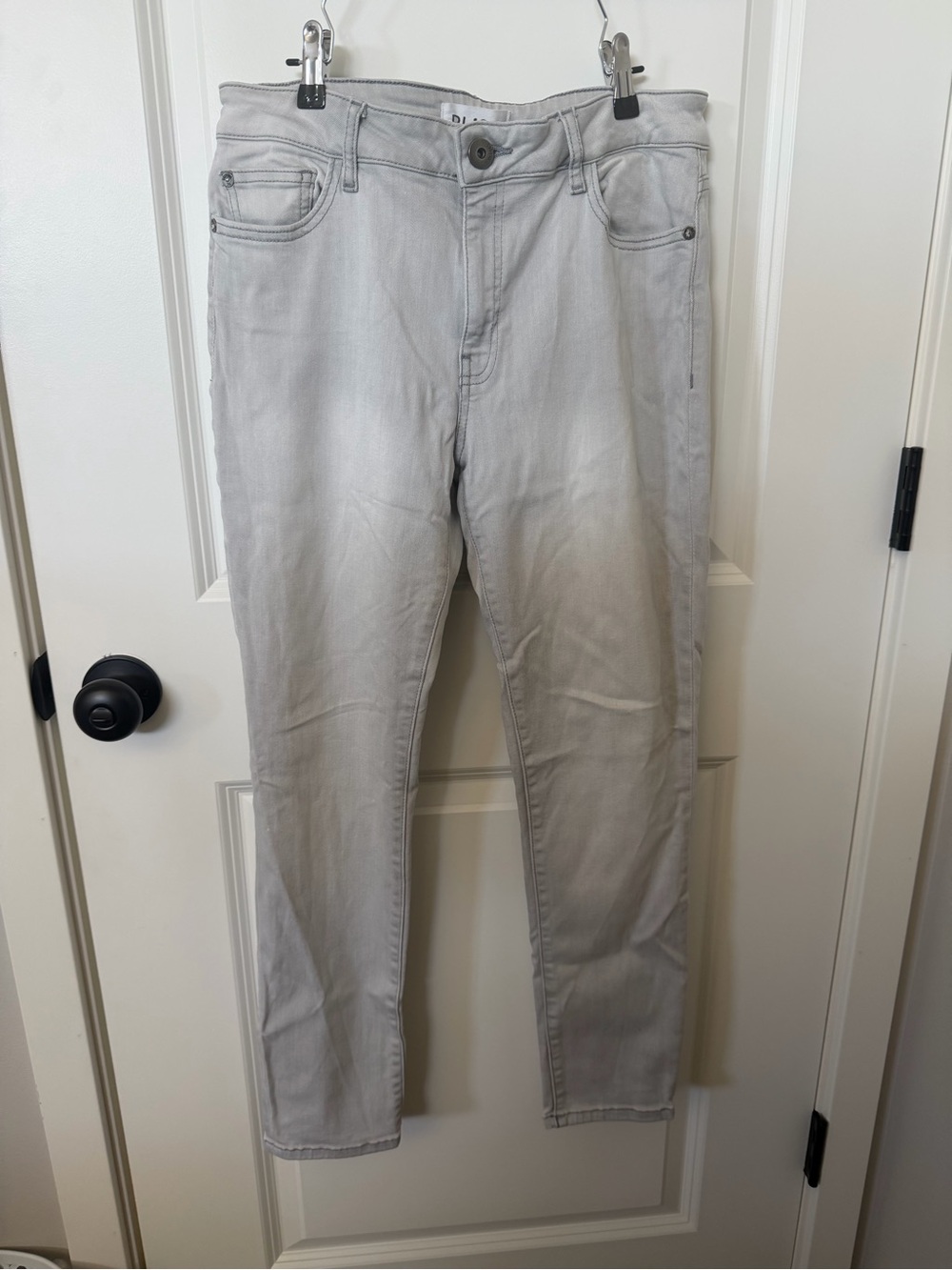 DL1961 denim jeans with a classic five-pocket design and front button closure.